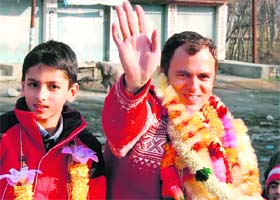 National Conference president Omar Abdullah along with his son waves towards party supporters after being declared elected from Ganderbal constituency in Srinagar