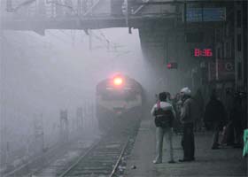 A train enters the fog-engulfed railway station in Amritsar