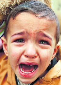 A relative of Palestinian police chief Tawfiq Jaber, who was killed in an Israel air strike, cries during his funeral in Gaza Strip