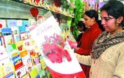 With New Year festivities approaching, young girls take a look at greeting cards in Amritsar