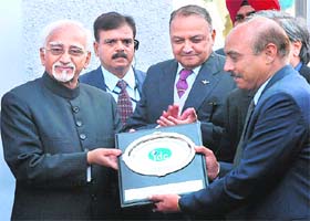 Vice-President Mohammed Hamid Ansari (extreme left) receives a memento during the inauguration of a new block at the Institute for Development and Communication, Sector 38, Chandigarh