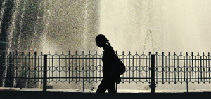 A girl passes by a fountain on the Jammu University campus.