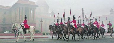 The cavalry unit of the security of Rashtrapati Bhavan returns after the change-of-guard ceremony on a foggy morning in New Delhi.