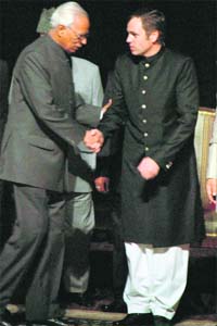Abdullah the third: Omar Abdullah (right) shakes hands with Jammu and Kashmir Governor N.N. Vohra after he was sworn in as chief minister in Jammu