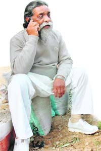 Jharkhand CM Shibu Soren talks on his mobile after his defeat in the Tamar byelection, in Ranchi