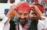 Film star Sanjay Dutt adjusts his Samajwadi Party cap during a roadshow in Lucknow on Saturday.