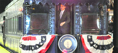 US President-elect Barack Obama looks out from the back of a train on Saturday as he departs Philadelphia en route to Washington on the Whistle Stop Tour.