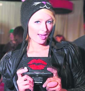 Paris Hilton poses with her customised Nintendo DS handheld game during the Sundance Film Festival at the Sephora Lounge in Park City, Utah