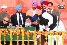 Sukhbir Badal seeks his fathers blessings after he was sworn in Deputy Chief Minister of Punjab in Amritsar