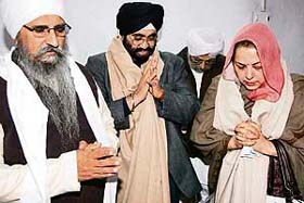 Daljit Singh Pinki (centre), brother of Prime Minister Manmohan Singh, and his wife offer prayers at a gurdwara in Amritsar