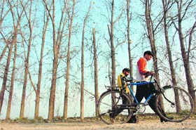Two boys walk along the road in the RS Pura area on the outskirts of Jammu