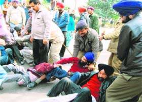 Policemen arrest members of the Netarheen Jagriti Sangh during a protest in Chandigarh