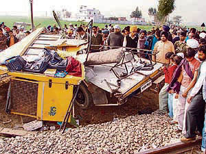 The wreckage of the school bus that was hit by a railway engine near Talwandi Bhai in Ferozepur district on Monday.