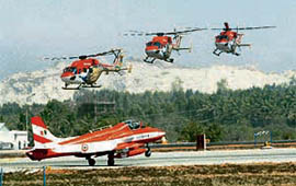 A team of Sarang helicopters lands during a rehearsal for Aero India 2009 in Bangalore on Monday.