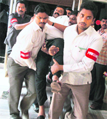 Marshals carry out an Opposition MLA from Andhra Assembly in Hyderabad on Wednesday.