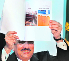 Rehman Malik, Pakistan's interior ministry chief, shows a picture of a boat used in the Mumbai attacks, during a press conference in Islamabad on Thursday.