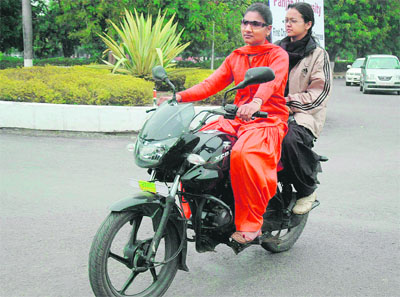 Why should boys have all the fun? These two dames prove their zest for biking at Sector 15 roundabout