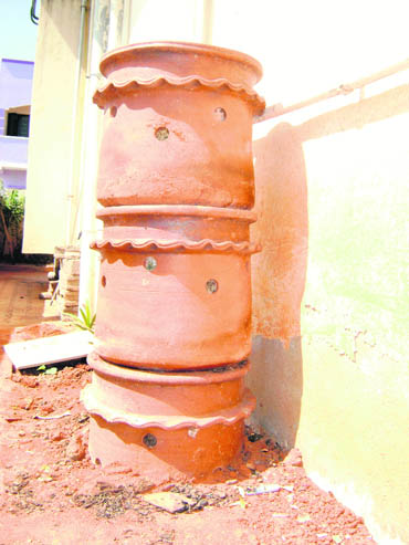 The quaint three-tiered urn-like terracotta object is called 'kambha', a compost bin for organic garbage