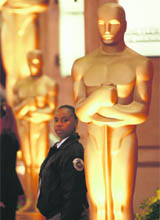 A security officer stands next to an Oscar statue during preparations for the 81st Academy Awards at the Kodak Theatre in Hollywood, California.