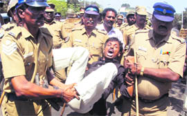Policemen detain a student during a protest against Sri Lankan President Mahinda Rajapakse in Chennai on Tuesday.