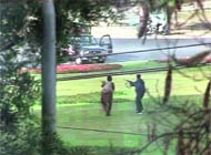 A video grab shows gunmen firing in the direction of a police vehicle in Lahore on Tuesday.