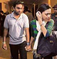Sri Lankan cricket team captain Mahela Jayawardene walks out of the Colombo airport terminal along with his wife Christina Sirisena on Wednesday.