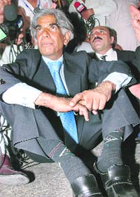 Ali Ahmed Kurd, president of the Pakistani Supreme Court Bar Association, sits on the ground after security officials stopped him during an anti-government protest march in Dera Allah Yar