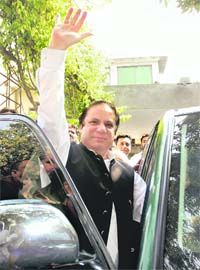 Pakistan Muslim League (N) leader Nawaz Sharif waves to his supporters as he leaves his home in Lahore