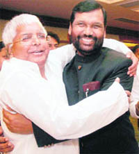 RJD leader Lalu Prasad Yadav and LJP chief Ram Vilas Paswan celebrate their seat-sharing arrangement in Delhi on Tuesday.