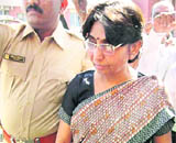 Gujarat state Child Welfare and Higher Education Minister Mayaben Kodnani walks to surrender before SIT in Gandhinagar on Friday.