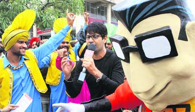 assi sings a number from his album during a show organised in Sector 17 while a mascot looks on.