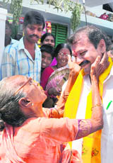 A woman blesses Telugu Desam Party candidate Talasani Srinivas Yadav as he campaigns in Hyderabad on Friday.