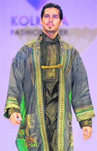 Actor Dino Morea presents a creation from Indian designer Sharbari Dutta