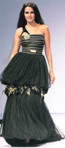 Neha Dhupia displays an outfit designed by Falguni and Shane Peacock