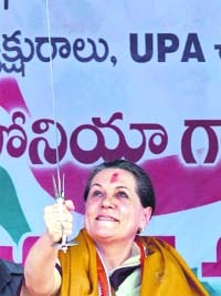 Congress president Sonia Gandhi holds a sword presented to her by a party member at a rally in Karimnagar, 210 km from Hyderabad