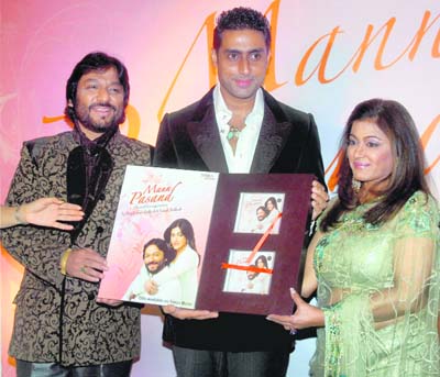 Actor Abhishek Bachchan releases singer-couple Roop Kumar Rathod (L)