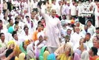 A TV grab of a man, identified as Ram Bal, throwing a shoe at Cong MP Navin Jindal during a rally in Kurukshetra on Friday.