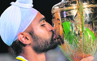 AFTER A LONG WAIT OF 13 YEARS: Indian captain Sandeep Singh kisses the winners trophy after India beat Malaysia in the final of the Sultan Azlan Shah Cup field hockey in Ipoh, Malaysia