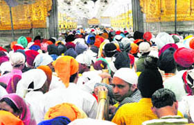 Devotees pay obeisance at Harmandar Sahib, Amritsar, on the eve of Baisakhi on Monday.