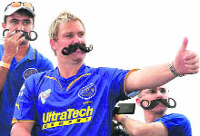 Rajasthan Royals coach and captain Shane Warne gestures to crowd during the IPL gala parade in Cape Town on Friday.