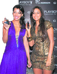Bollywood actors Mugdha Godse (L) and Neha Dhupia smile during the unveiling ceremony of international 'Playboy' perfume in Mumbai.