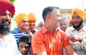 Bumb sarpanch Balwinder Singh (extreme left) and village youths are all smiles after deciding not to entertain political parties that distribute drugs and alcohol for votes in the Lok Sabha elections