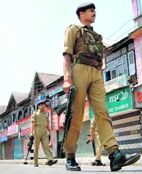 CRPF personnel patrol deserted streets at Lal Chowk in Srinagar on Wednesday to thwart planned protests against holding elections