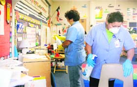 Workers from the Richardson Independent School District work to disinfect a classroom inside Canyon Creek Elementary School, which was shut down after one case of swine flu was confirmed in Richardson, Texas