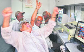 Euphoric traders react inside a brokerage in Ahmedabad on Monday.