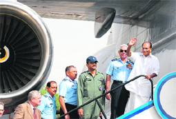 Defence Minister AK Antony waves as IAF chief FH Major looks on during the inspection of AWACS in New Delhi on Thursday.