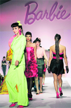Models present creations designed by 50 Filipino designers in commemoration of the 50th anniversary of Barbie Doll during Philippine Fashion Week in Manila recently.