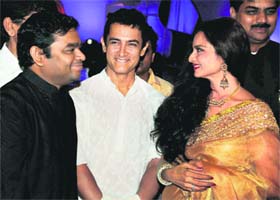 Bollywood actors Rekha and Aamir Khan chat with music director A.R. Rahman (L) at a function in Pune on Saturday night