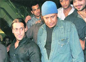 Hair and there Bollywood actors Salman Khan (L) and Mithun Chakravarty (C) arrive for the opening ceremony of a hair and tattoo lounge in Mumbai recently