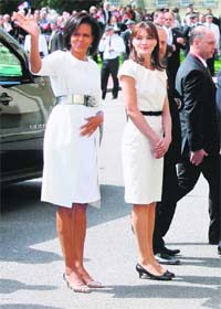 WOMEN IN WHITE: US First Lady Michelle Obama (L) and French First Lady Carla Bruni-Sarkozy (R) at the Caen Prefecture in France recently. AFP photo: THIERRY CHESNOT